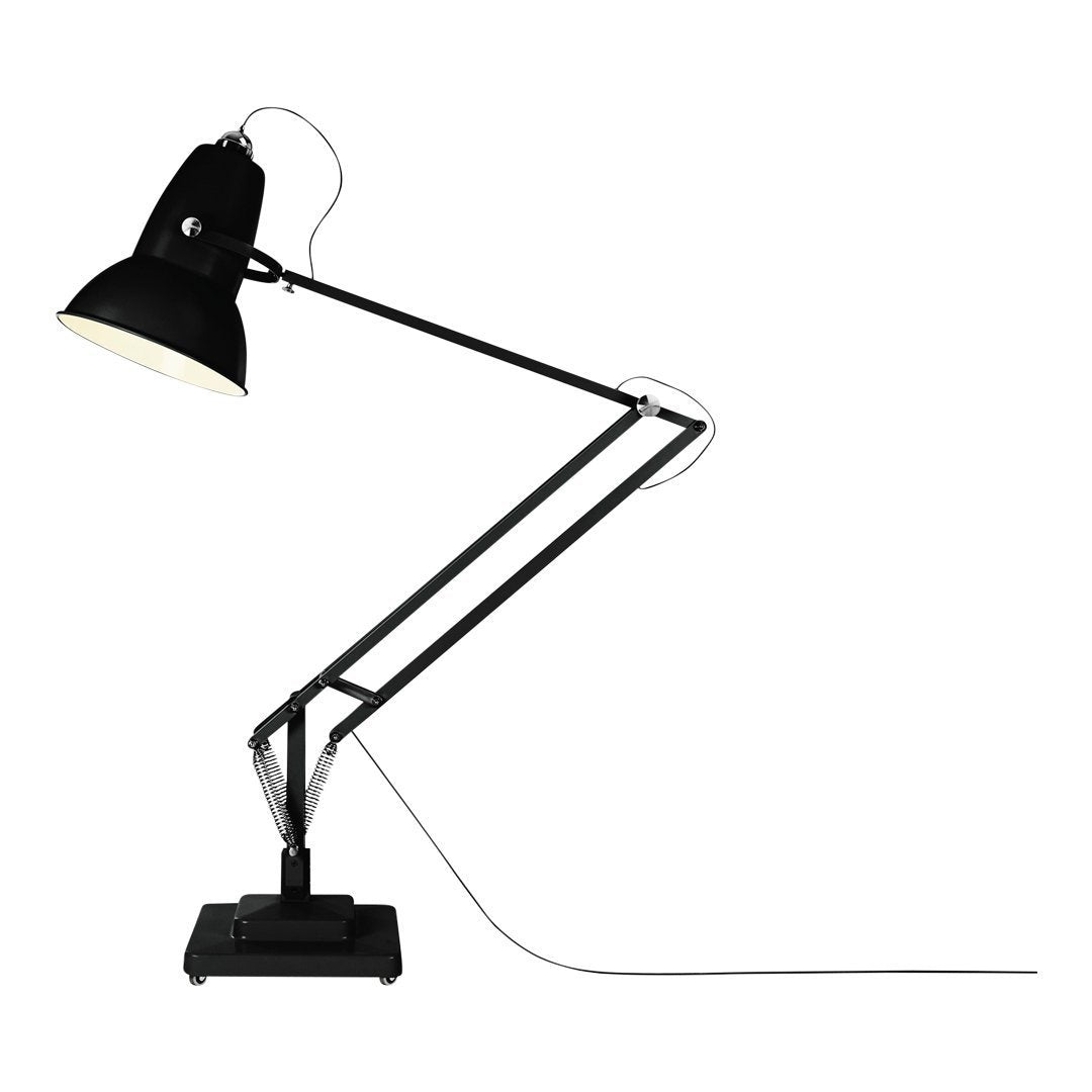 Black and silver adjustable desk lamp with a matte finish and sleek industrial design. Perfect for modern decor.