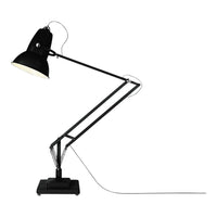 Black and silver adjustable desk lamp with a matte finish and sleek industrial design. Perfect for modern decor.