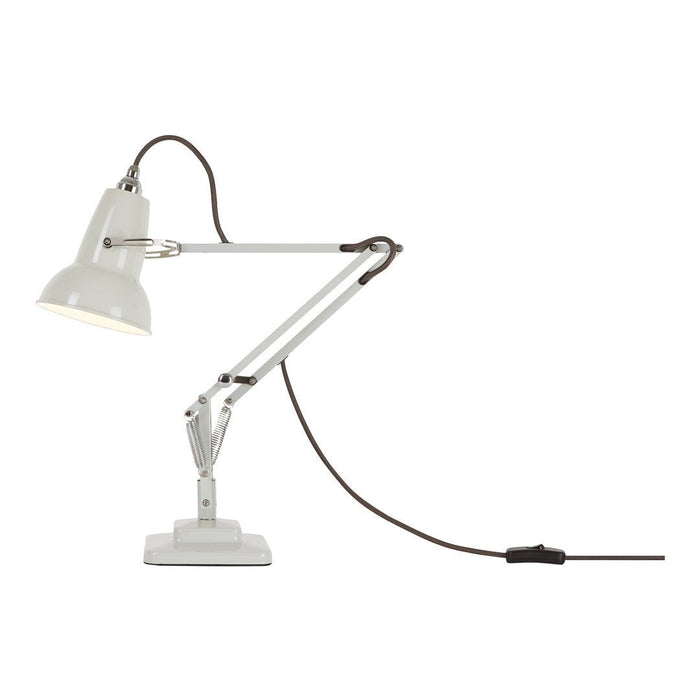 White desk lamp with a sleek design and brown cable. Perfect for modern interiors.