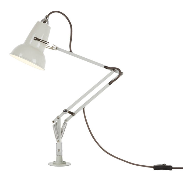 White adjustable desk lamp with metal finish and brown cord, featuring sleek, modern lines and minimalistic design.