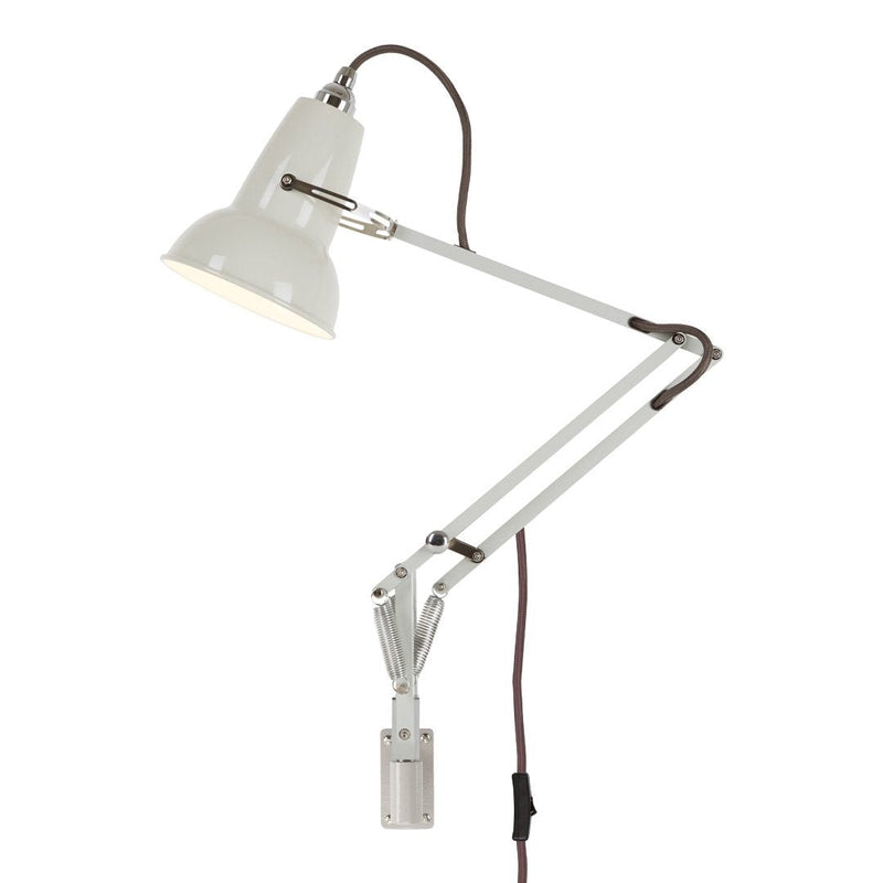 White adjustable desk lamp with a glossy finish and brown fabric cord. Modern industrial design with sleek lines.
