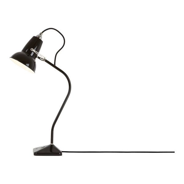 Black desk lamp with a sleek, curved design and a contrasting white interior, featuring a minimalistic style.