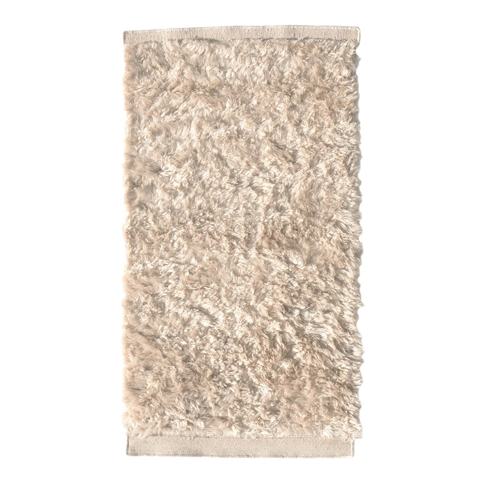 Textured, shaggy area rug in soft beige tones, featuring a plush, fluffy pattern for cozy decor.