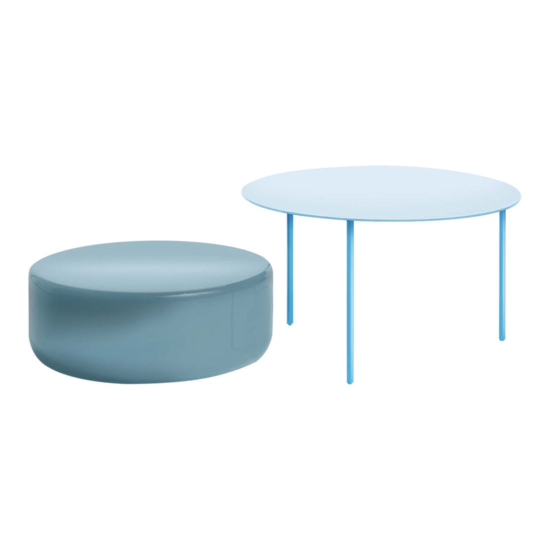 Light blue round table and soft blue pouf, featuring a sleek, modern design with smooth surfaces.