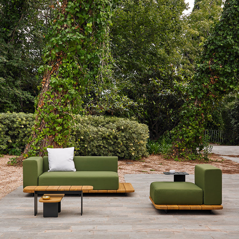 Green outdoor sofa set with wood accents, featuring a solid-colored upholstery and a contrasting white throw pillow.