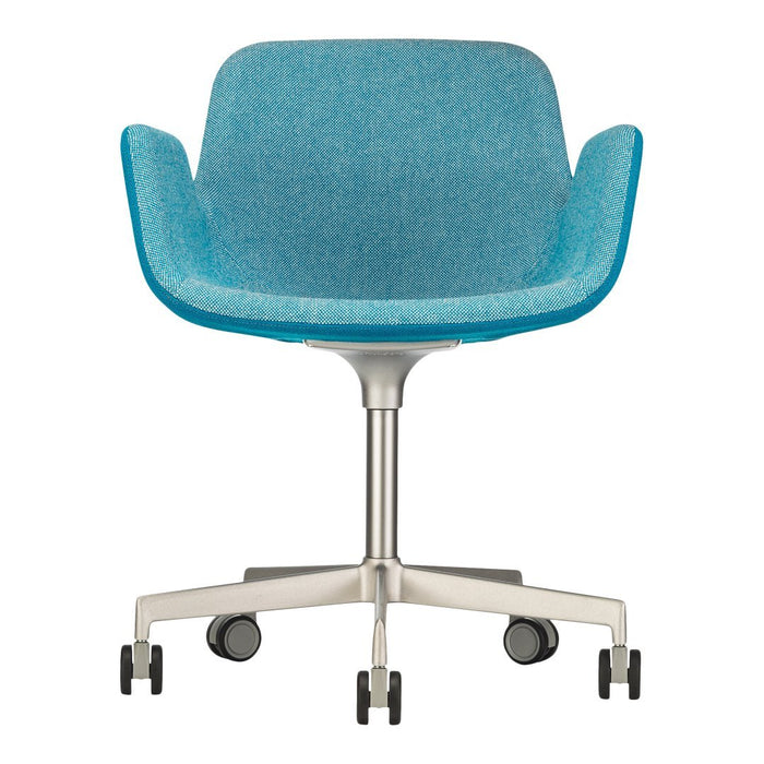 "Teal upholstered chair with smooth, curved lines and a sleek metal base, featuring a minimalist design."
