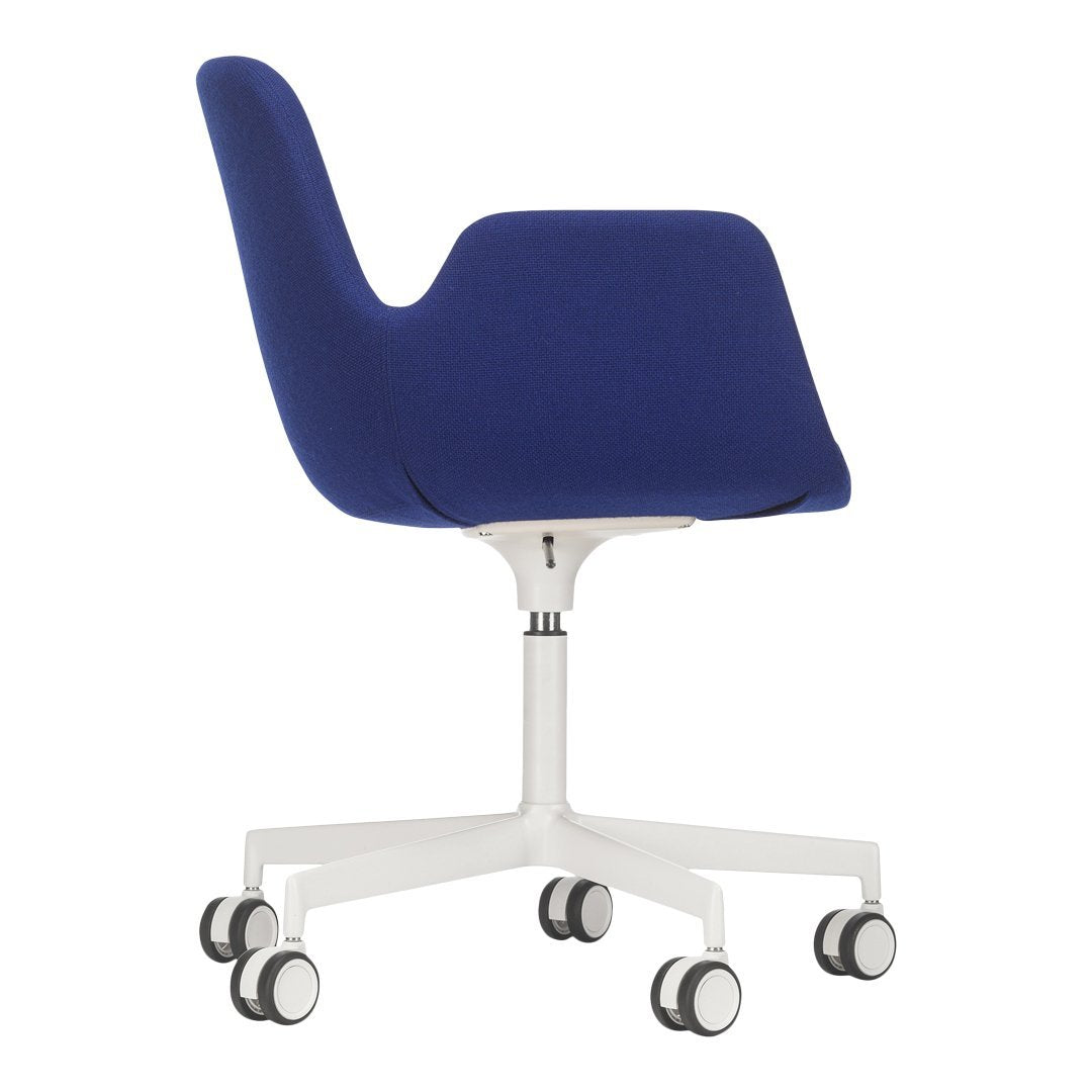Blue upholstered chair with a sleek, modern design and contrasting white base on rolling wheels.