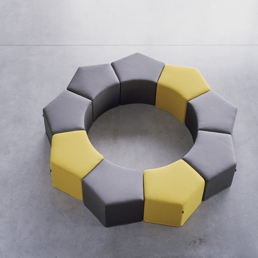 Hexagonal seating in gray and yellow, featuring a modern pattern for contemporary decor. Perfect for playful spaces.