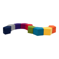Colorful hexagonal seating in vibrant shades of purple, pink, green, blue, yellow, and orange, arranged in a curved pattern.