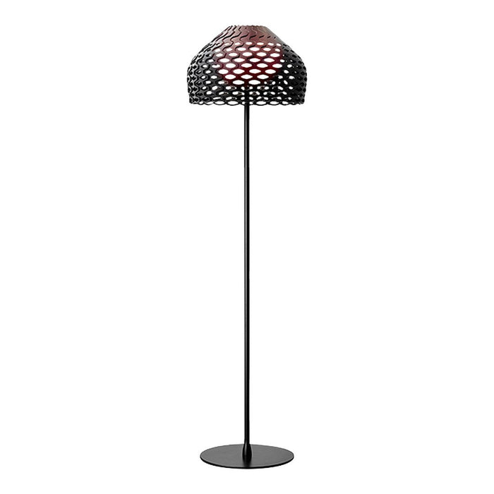 Black floor lamp with a patterned shade featuring a mesh design and a warm red interior. Elegant and modern aesthetic.