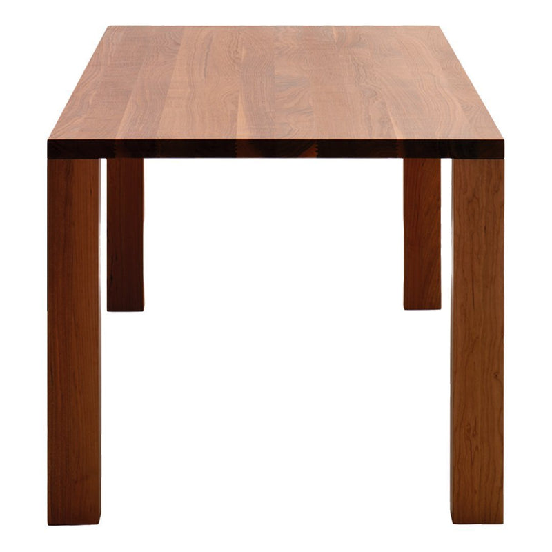 Wooden dining table in rich brown tones with a smooth, natural wood grain pattern. Minimalist design with sturdy legs.