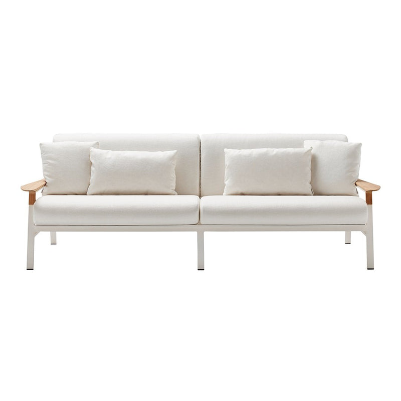 White sofa with cream cushions and light wood accents, featuring a minimalist design and seamless lines.