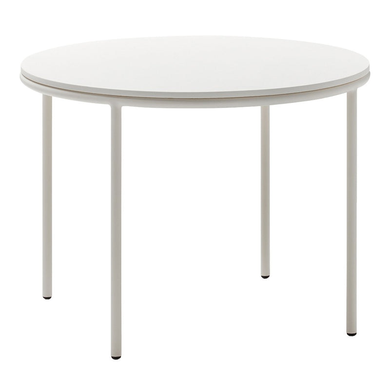 Round white table with a smooth surface and sleek metal legs, perfect for modern dining spaces.