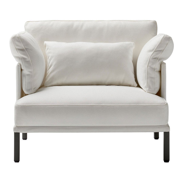 Modern white armchair with plush round armrests and a matching lumbar pillow on a sleek black metal frame.