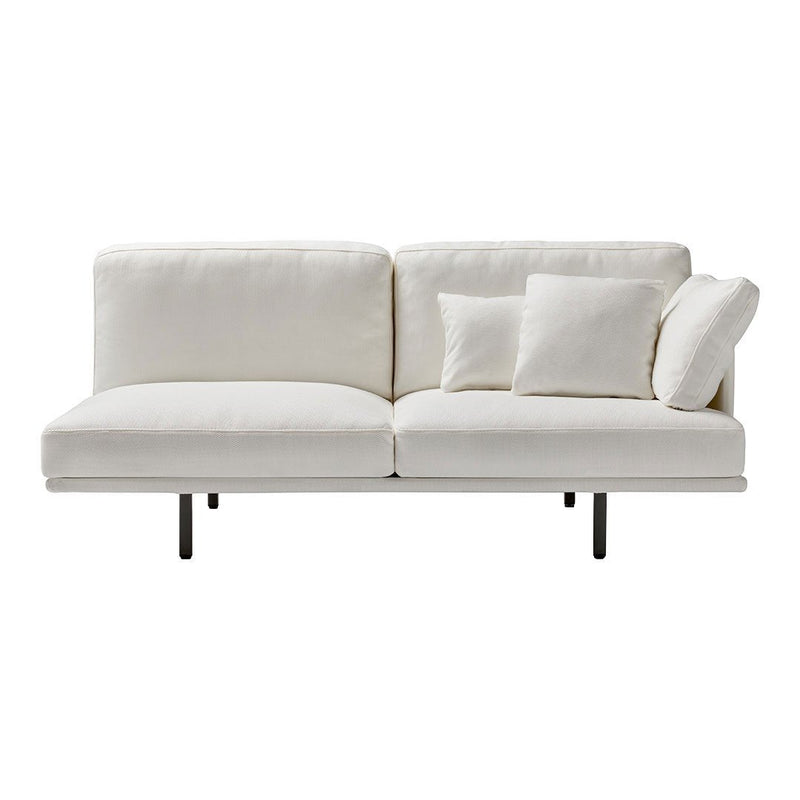 White sofa with smooth fabric, featuring plush cushions in varying sizes on a minimalist black metal frame.