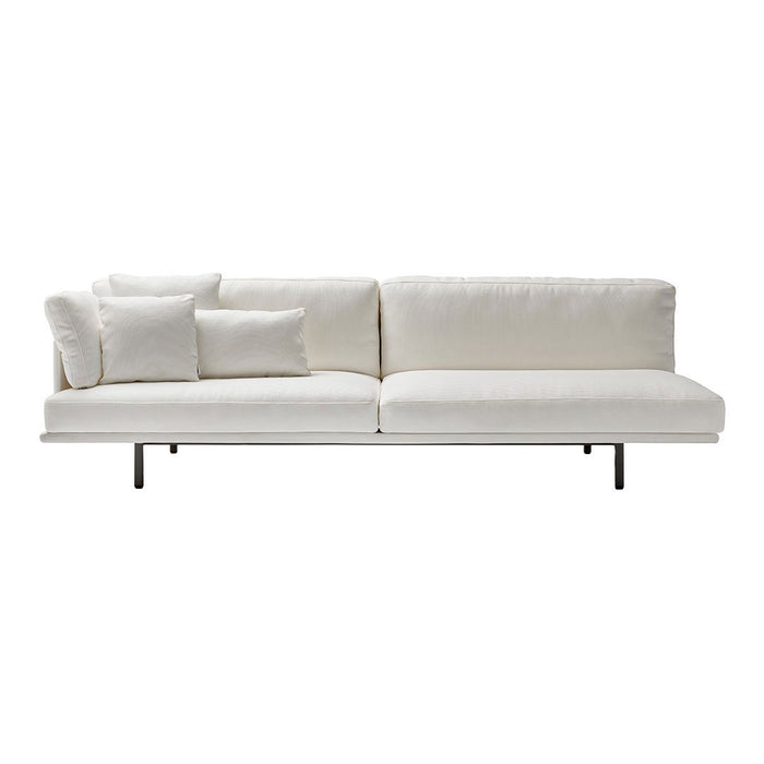 Modern white sofa with textured cushions and sleek metal legs, perfect for a minimalist aesthetic.
