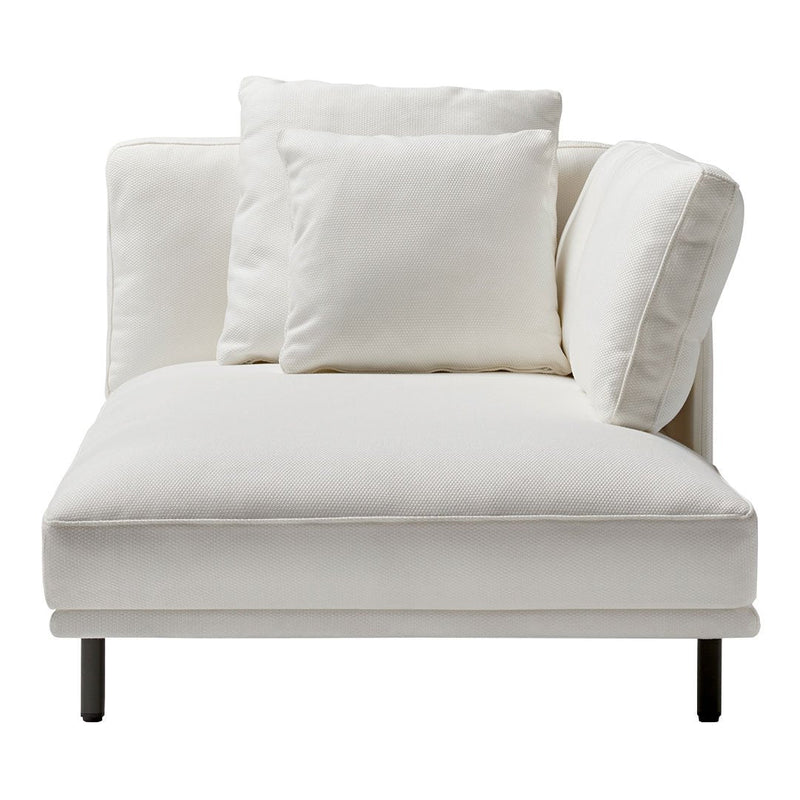 Modern white chaise lounge with plush cushions, showcasing a minimalist design and clean lines. Perfect for any decor.