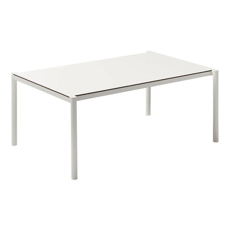 White rectangular table with a smooth, glossy surface and minimalist design. Modern aesthetic with sleek metal legs.