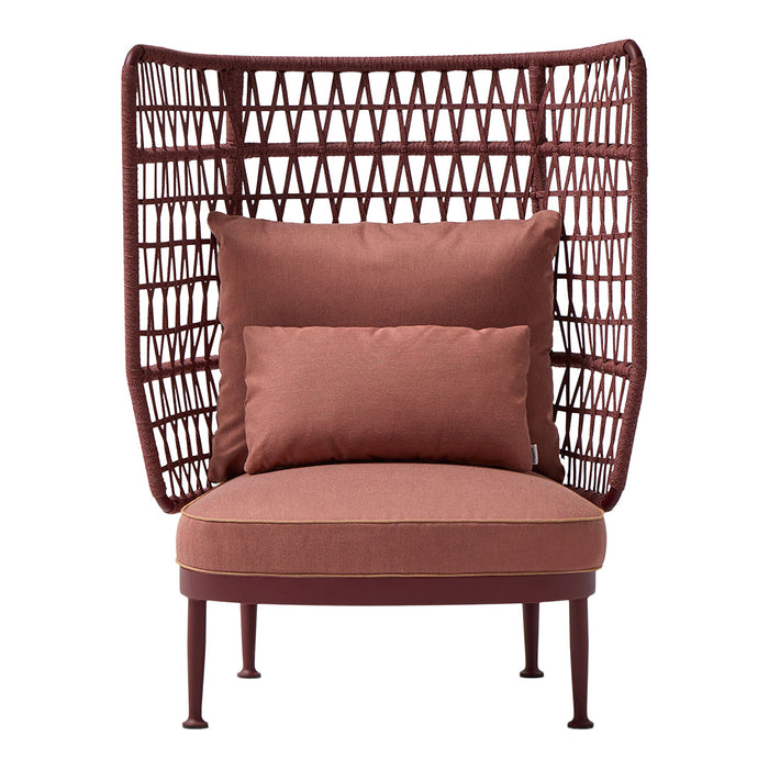 Rust-colored chair with geometric woven backrest and plush cushions, perfect for modern decor.