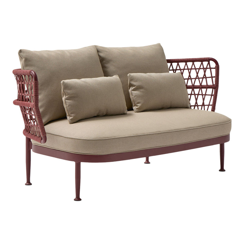 Beige fabric cushions on a rust-colored metal frame with intricate weaving patterns, perfect for modern outdoor decor.