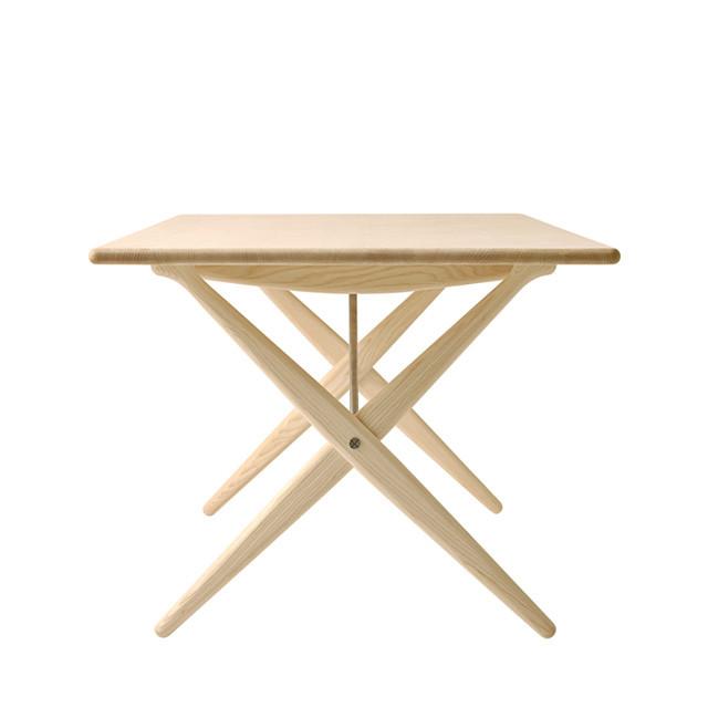 Natural light wood folding table with a clean, minimalist design and smooth surface. Ideal for various settings.