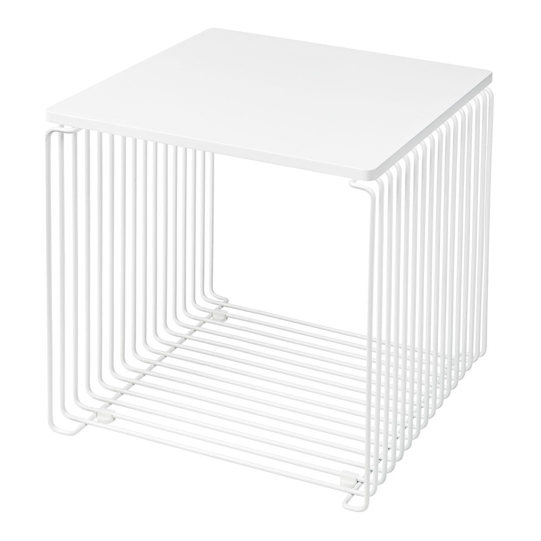 White wireframe cube side table with a sleek, minimalist design and open slat pattern. Perfect for modern decor.