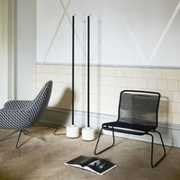 Black and white geometric patterns with sleek black metal and soft beige tones in a modern interior setting.