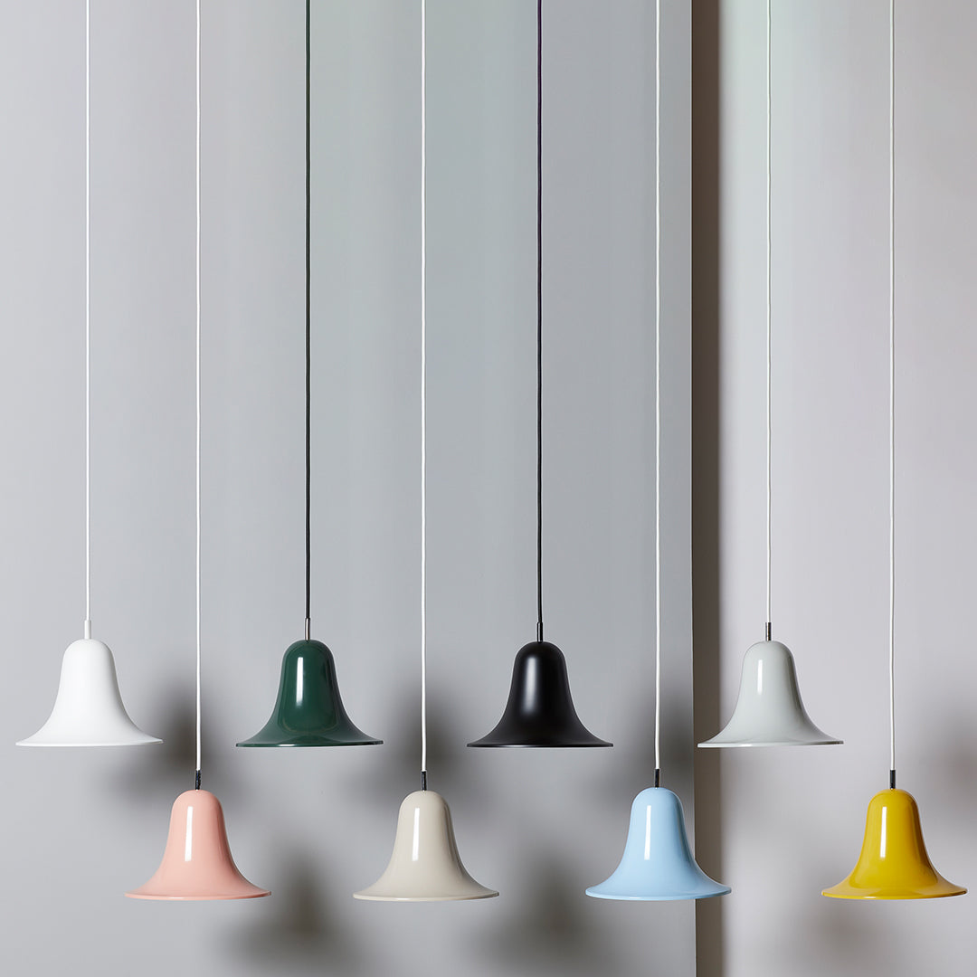 Eight bell-shaped pendant lights in white, green, black, pink, cream, blue, yellow, and grey. Modern color palette.