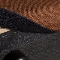Textured fabric layers in rich brown, navy blue, and charcoal gray, showcasing diverse patterns and finishes.