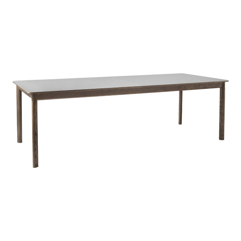 Rectangular dining table with a sleek gray surface and metallic legs, featuring a minimalist design.