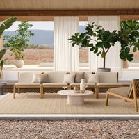 Neutral beige seating with light wood accents, set against green plants and natural textures for a serene outdoor vibe.