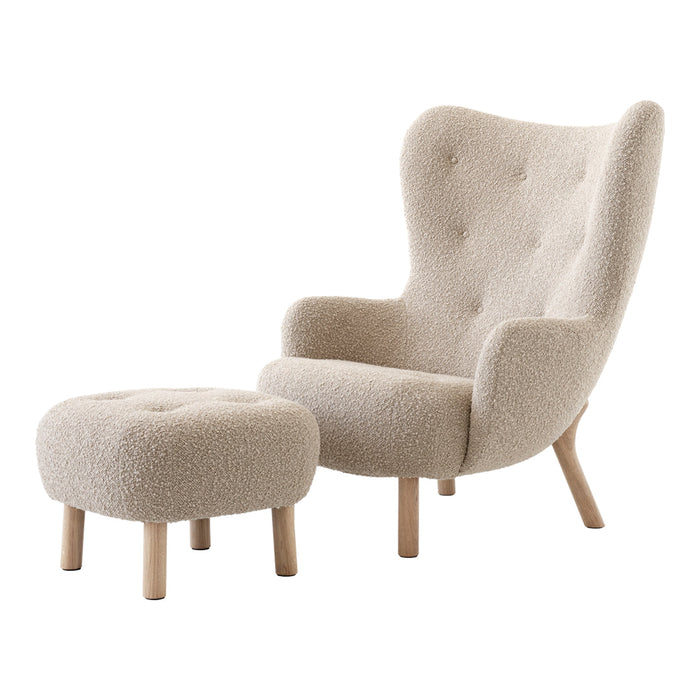 Cream-colored upholstered armchair with a matching ottoman, featuring a soft, textured fabric and natural wood legs.
