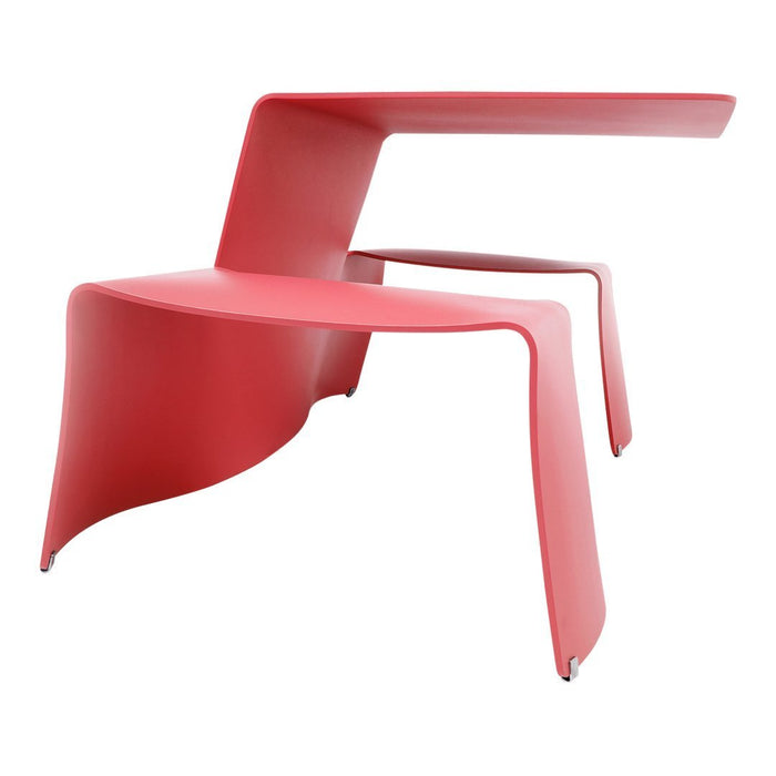 Red sculptural chair with a sleek, modern design and smooth contours, perfect for contemporary decor.
