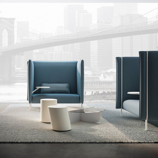 Contemporary blue armchair with white accents, set against a modern urban backdrop featuring soft gray tones.