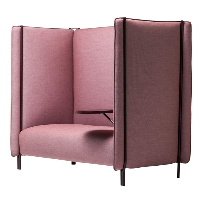 "Soft pink upholstered lounge chair with sleek black accents and a minimalist design."