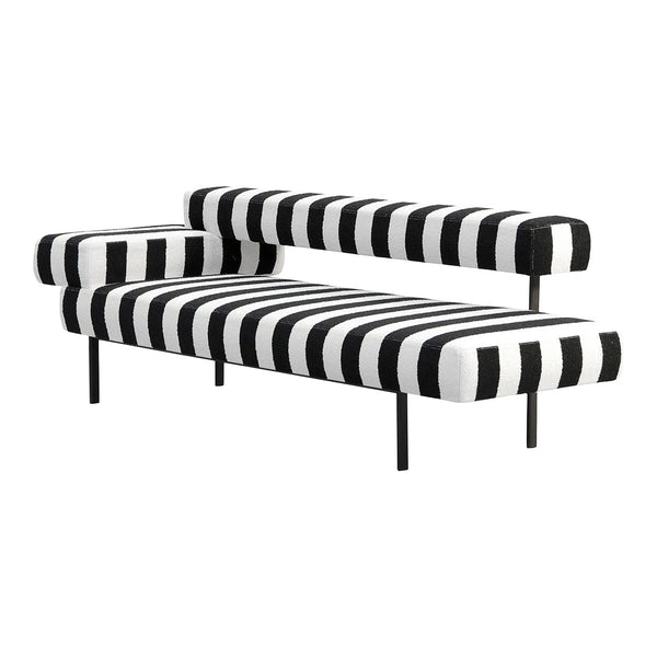 Black and white striped sofa with bold zigzag pattern, modern design, and sleek black metal legs.