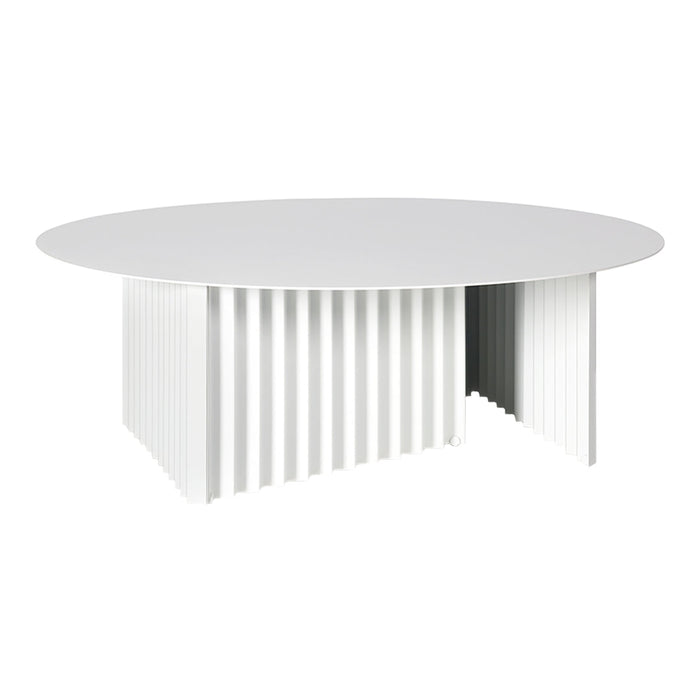 White round table with a textured ribbed base, featuring a sleek and modern minimalist design.