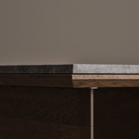 Dark wood base with sleek gray stone top, featuring a smooth, polished finish and clean lines.
