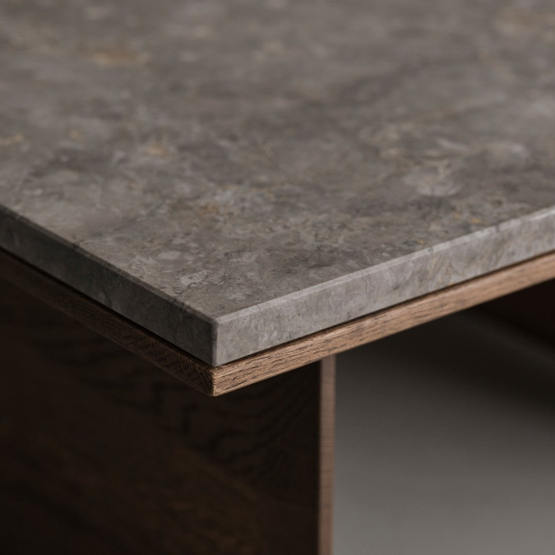 Gray textured tabletop with subtle patterns, featuring a sleek edge and warm brown base. Perfect for modern interiors.