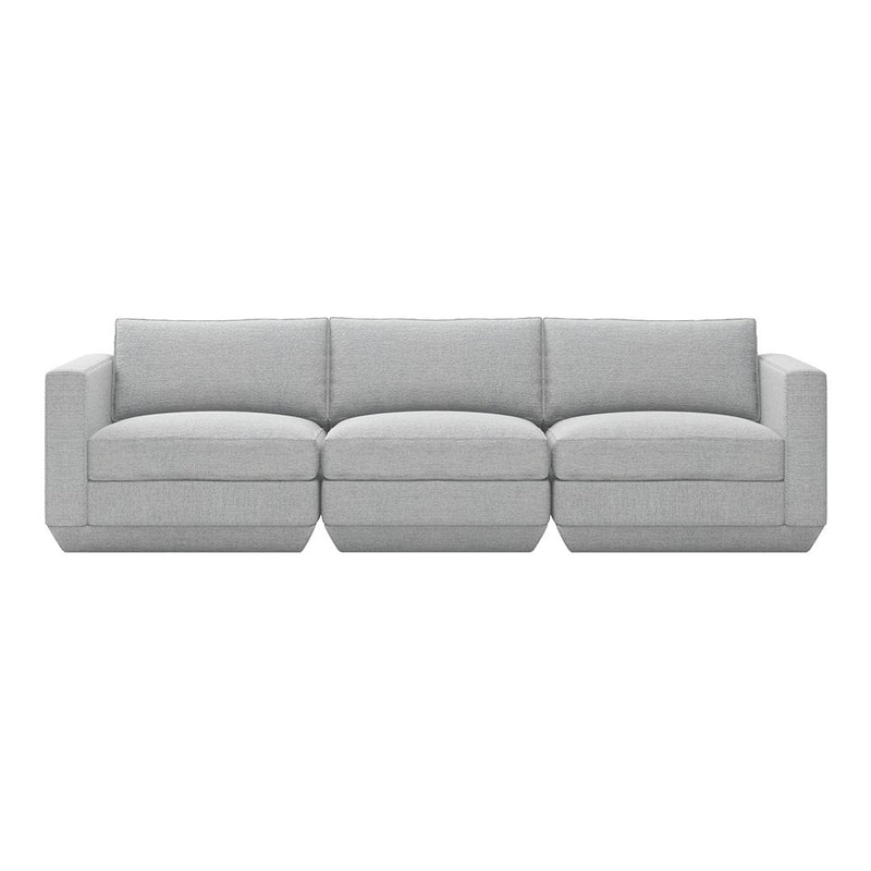 Gray sectional sofa with a modern, minimalist design and soft fabric upholstery, featuring clean lines and no patterns.