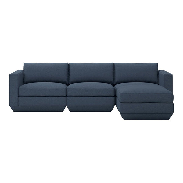 Navy blue sectional sofa with a solid fabric pattern, featuring plush cushions and a modern design.