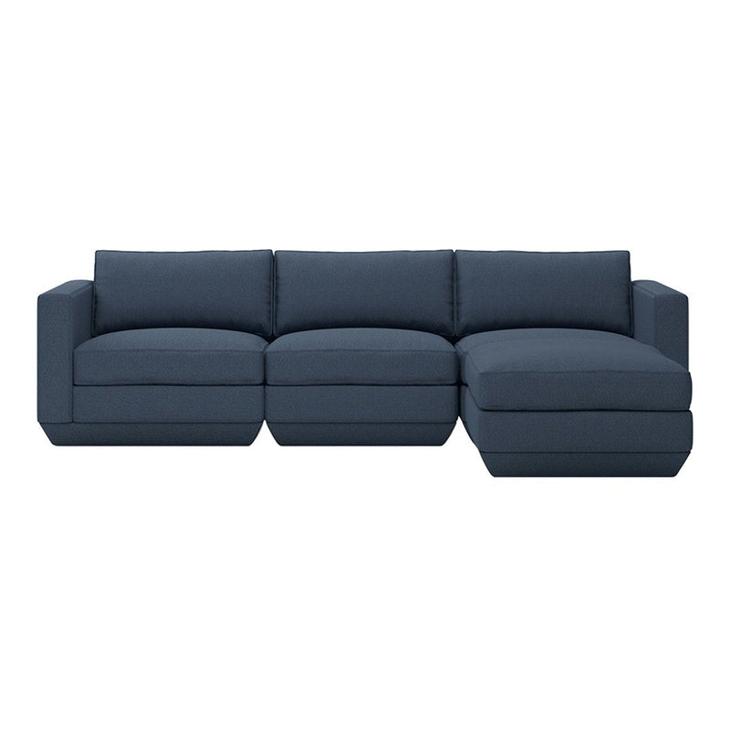Navy blue sectional sofa with a solid fabric pattern, featuring plush cushions and a modern design.