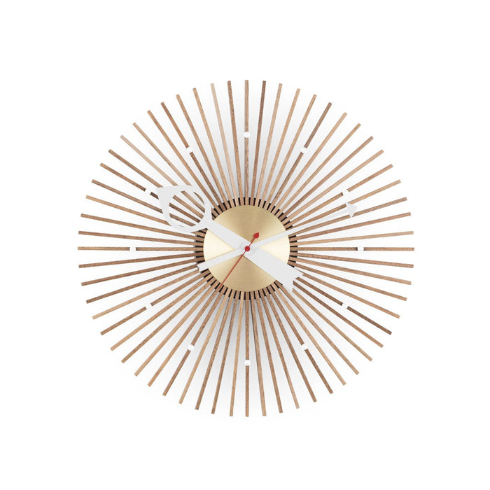 Modern wall clock featuring a sunburst design with wood and gold accents on a white background.