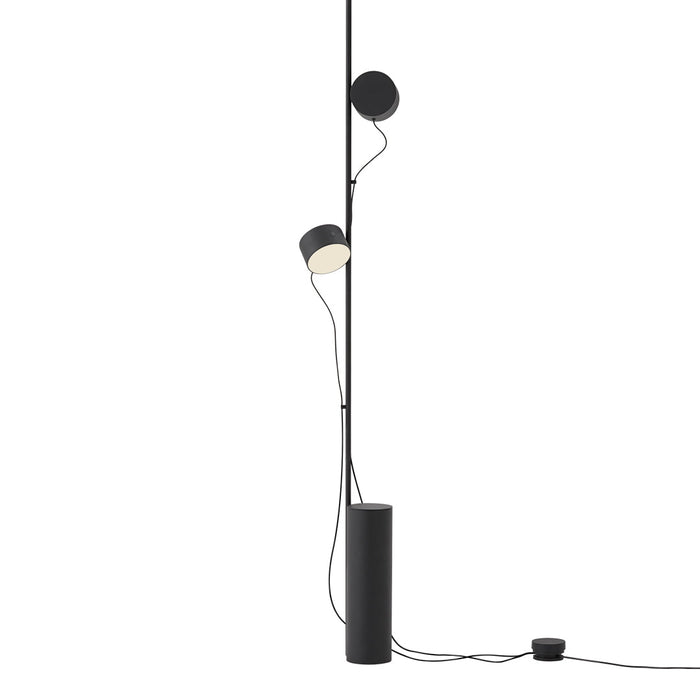 Black and white modern floor lamp with clean lines and minimalistic design, featuring circular and cylindrical shapes.