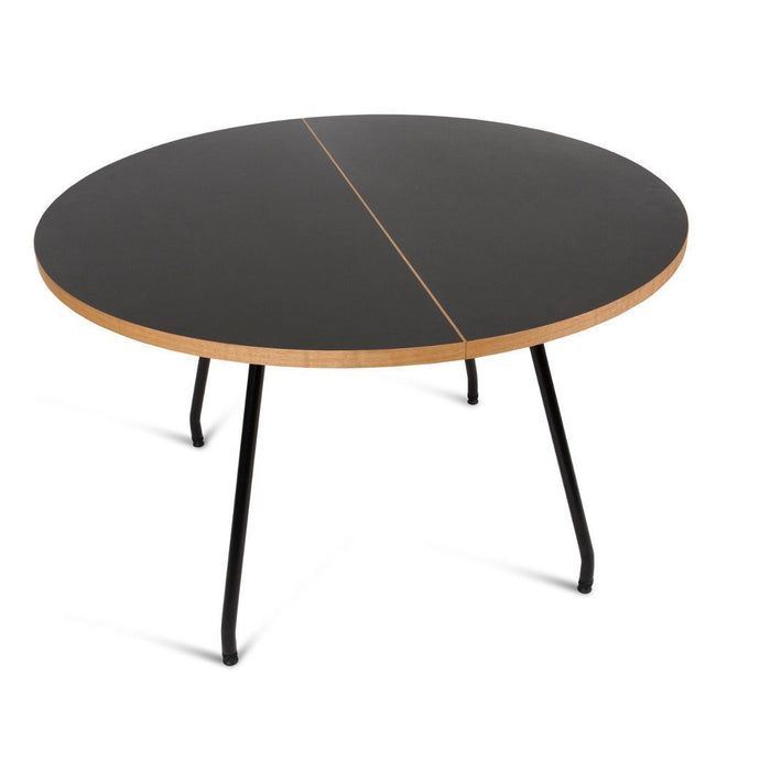 Round black table with a natural wood edge and minimalist design, featuring a sleek, modern aesthetic.