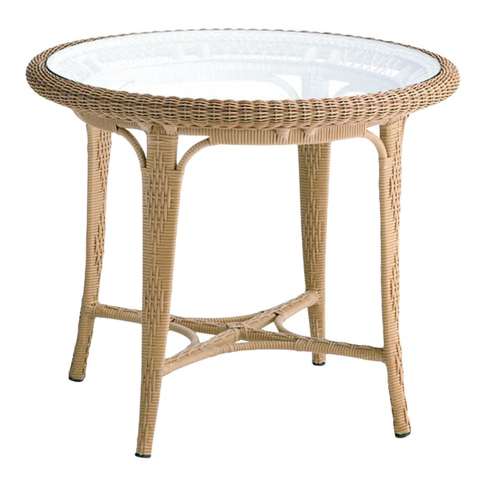 Round wicker patio table with a natural tan finish and a clear glass top, featuring a woven pattern design.