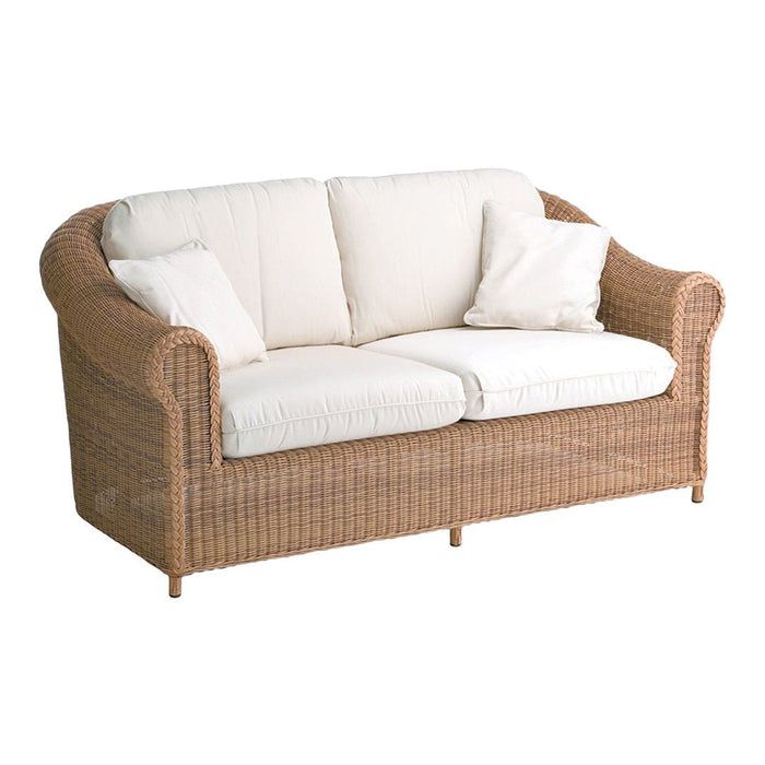 Cream upholstered cushions on a woven rattan sofa with a natural finish. Elegant and cozy design for indoor or outdoor use.