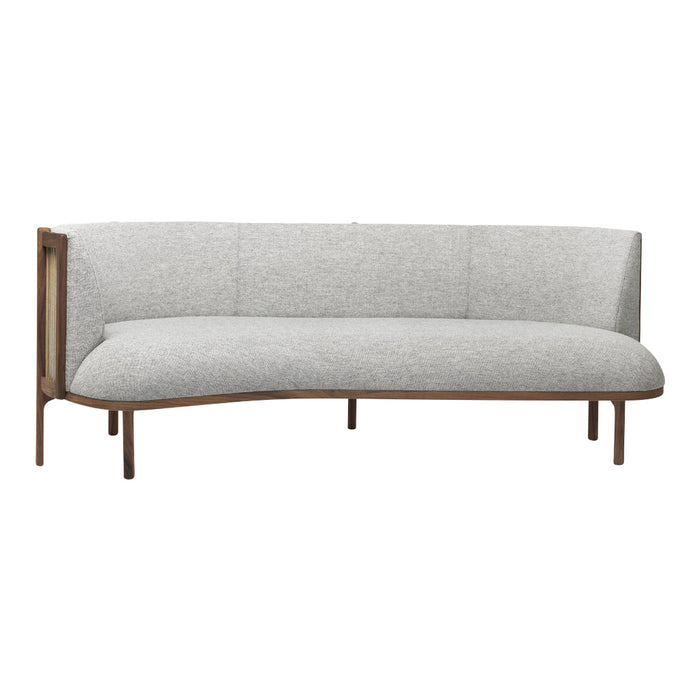 Modern curved sofa in soft grey fabric with warm wood accents. Ideal for elegant and contemporary spaces.
