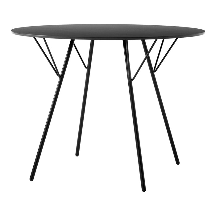 Black round table with sleek legs, showcasing a minimalist design and smooth surface for modern decor.