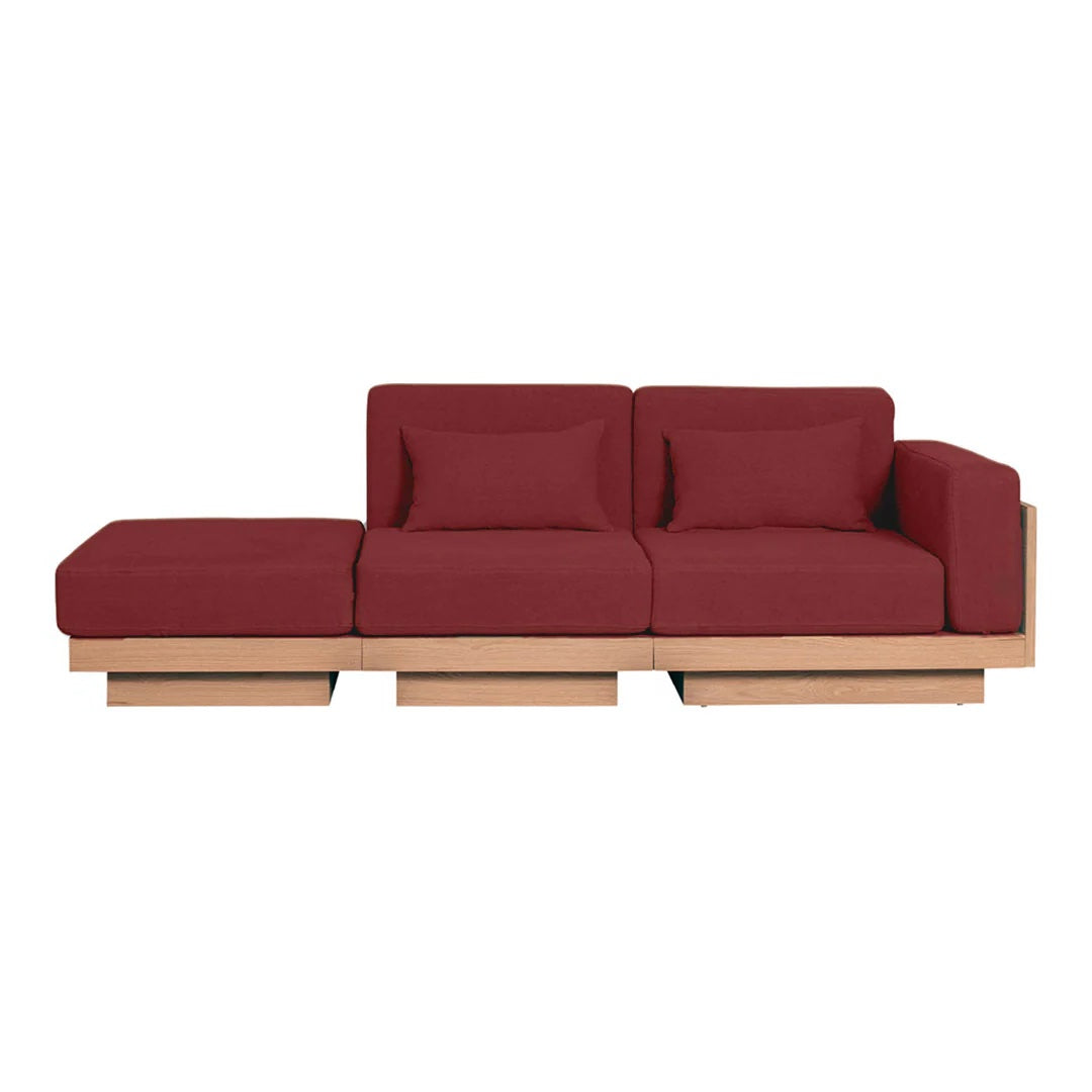 Modern burgundy sofa with clean lines and wooden base, perfect for contemporary living spaces.